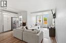 Open-concept living area featuring wood-finish flooring and white walls - 15 Nicklaus Drive Unit# 17, Hamilton, ON 