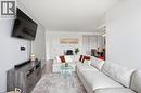 Open-concept living space featuring wood-finish flooring, light grey walls, and recessed lighting - 15 Nicklaus Drive Unit# 17, Hamilton, ON 