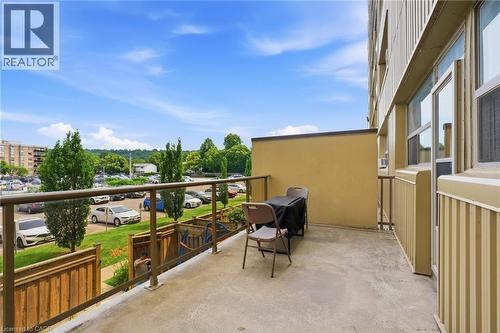 Concrete balcony with clear glass railing and metal frame, offering open-air space - 15 Nicklaus Drive Unit# 17, Hamilton, ON 