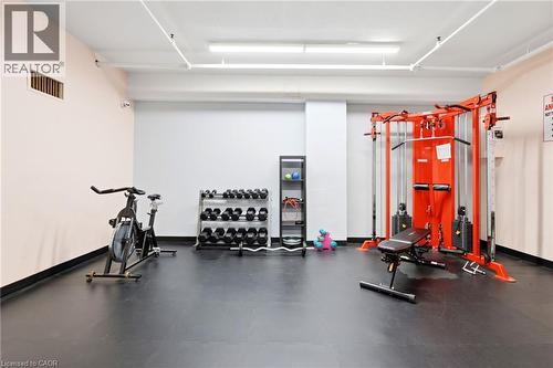 Dedicated fitness space featuring rubber flooring, track lighting, and a neutral color palette - 15 Nicklaus Drive Unit# 17, Hamilton, ON 