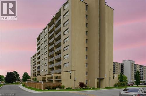 Multi-story residential building with private balconies and a neutral-toned facade - 15 Nicklaus Drive Unit# 17, Hamilton, ON 