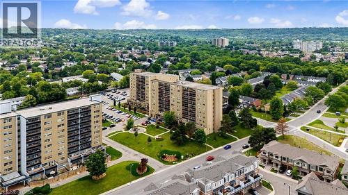 Aerial perspective showcasing multiple high-rise residential buildings surrounded by abundant mature trees and residential streets - 15 Nicklaus Drive Unit# 17, Hamilton, ON 