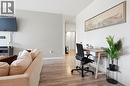 Open concept living space featuring light wood-finish flooring, a neutral color palette, and a built-in desk area - 15 Nicklaus Drive Unit# 17, Hamilton, ON 