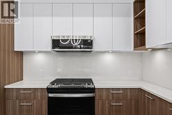 Kitchen. Photo of a similar floorplan/different colour scheme in building - 