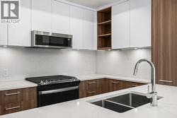 Kitchen. Photo of a similar floorplan/different colour scheme in building - 