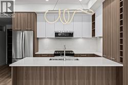 Kitchen. Photo of a similar floorplan/different colour scheme in building - 