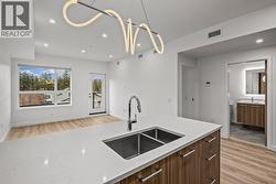 Kitchen. Photo of a similar floorplan/different colour scheme in building - 