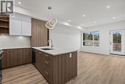 Kitchen & Dining. Photo of a similar floorplan/different colour scheme in building - 