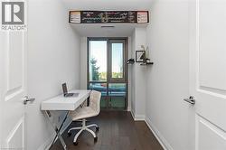 Dedicated alcove featuring wood-finish flooring and a large window - 