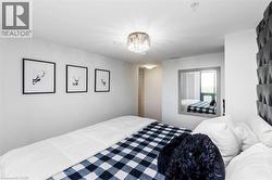 Recessed lighting illuminates a ceiling-mounted chandelier, complementing the room's white walls - 