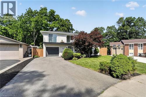 Contemporary-style residence featuring a white facade and a dark gray garage door - 9 Leslie Drive, Hamilton, ON - Outdoor