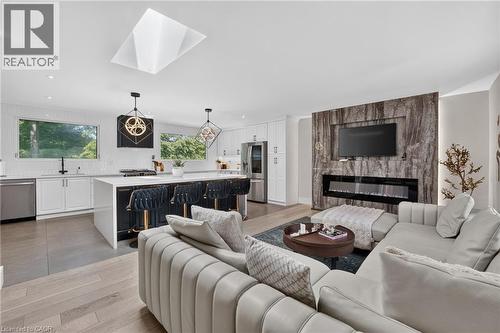 Open-concept living space with a contemporary kitchen and living area - 9 Leslie Drive, Hamilton, ON - Indoor Photo Showing Living Room With Fireplace