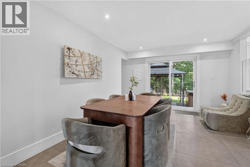 Recessed lighting illuminates the neutral wall colors and tile flooring - 9 Leslie Drive, Hamilton, ON - Indoor Photo Showing Dining Room
