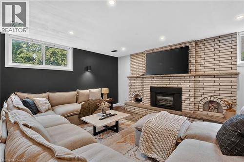 Integrated fireplace with a brick surround - 9 Leslie Drive, Hamilton, ON - Indoor Photo Showing Living Room With Fireplace