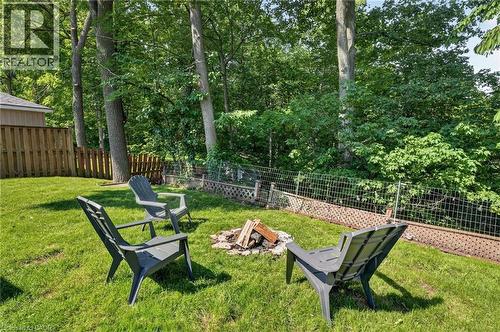 Expansive green lawn featuring a built-in fire pit - 9 Leslie Drive, Hamilton, ON - Outdoor