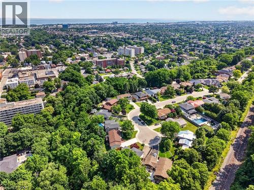 Aerial perspective showcasing a residential area with varied housing styles and mature tree coverage - 9 Leslie Drive, Hamilton, ON - Outdoor With View