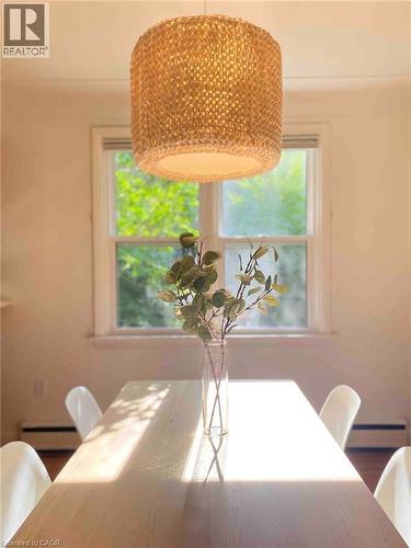 Woven pendant light fixture over a light wood-finish table - 919 Montgomery Drive, Ancaster, ON 