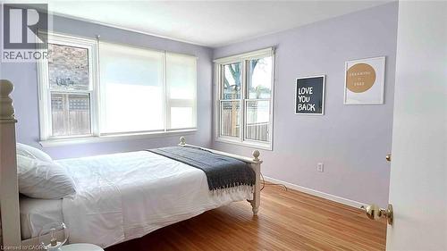 Hardwood flooring with a natural finish, white baseboards, and light-toned walls - 919 Montgomery Drive, Ancaster, ON 
