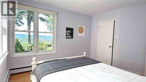 Double-hung windows with white trim, offering expansive tree-lined scenery - 919 Montgomery Drive, Ancaster, ON 