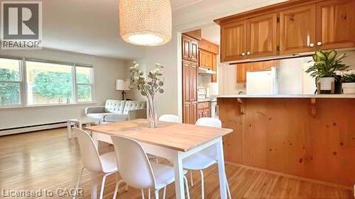 Open concept living and dining area featuring wood-finish flooring - 919 Montgomery Drive, Ancaster, ON 