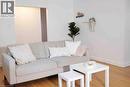 Bright living space featuring warm wood-finish flooring, crisp white walls, and a recessed wall opening - 919 Montgomery Drive, Ancaster, ON 