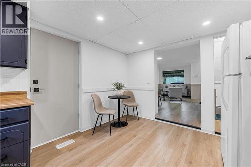 Open-concept area featuring light wood-finish flooring, white walls, and recessed lighting - 11 Ford Street, Hamilton, ON 