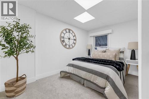White paneled wall accents complementing neutral carpeting - 11 Ford Street, Hamilton, ON 