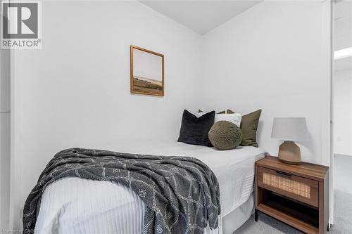 Bright interior space featuring light gray carpet, white walls, and a recessed ceiling - 11 Ford Street, Hamilton, ON 