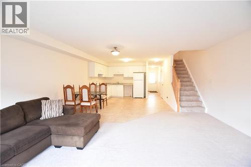 Open-concept living space featuring a kitchen, dining area, and living room - 52 Meadowridge Street, Kitchener, ON 