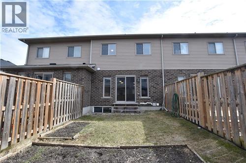 Rear exterior with brick and siding facade, featuring a patio with steps - 52 Meadowridge Street, Kitchener, ON 
