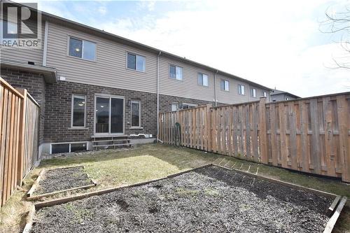 Enclosed backyard with wood privacy fencing - 52 Meadowridge Street, Kitchener, ON 