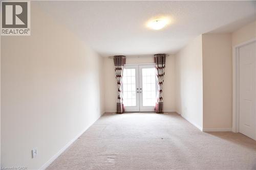 Room with light beige carpeting and neutral painted walls - 52 Meadowridge Street, Kitchener, ON 
