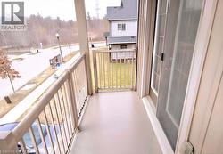 Private balcony with a light-toned floor and matching railings - 