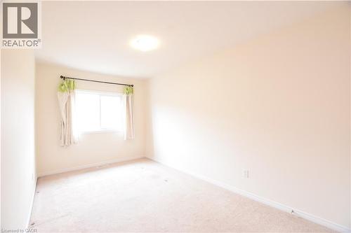 Bright room featuring a window with natural light, neutral wall paint, and plush carpeting - 52 Meadowridge Street, Kitchener, ON 