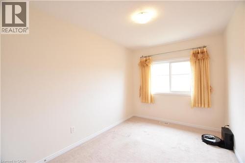 Neutral-toned walls and plush carpeting provide a versatile foundation for personalization - 52 Meadowridge Street, Kitchener, ON 