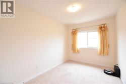 Neutral-toned walls and plush carpeting provide a versatile foundation for personalization - 