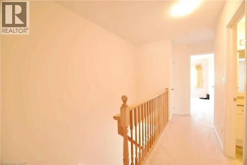 Upper level hallway featuring light-toned carpeting and neutral wall paint - 52 Meadowridge Street, Kitchener, ON 