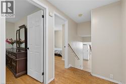 Hardwood-style flooring extends through the hallway and into a visible room - 