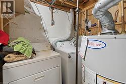 Laundry area featuring a washer, dryer, and water heater - 