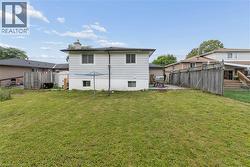 Expansive backyard featuring a sloped lawn - 