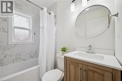 Bathroom featuring vanity and shower / tub combo with curtain - 