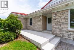 Stone veneer facade with a concrete porch and steps - 
