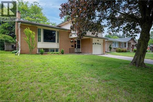 Brick-clad exterior with a prominent bay window, attached single-car garage, and a concrete driveway - 99 Lorraine Avenue, Kitchener, ON - Outdoor