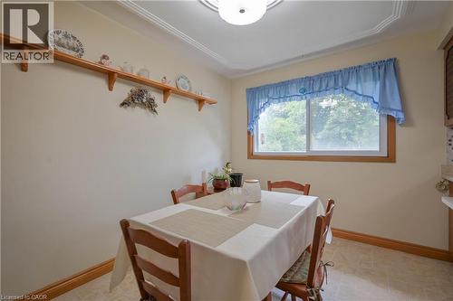 Built-in wood shelving unit, crown molding, and window with wood-finish trim - 99 Lorraine Avenue, Kitchener, ON - Indoor Photo Showing Dining Room