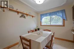 Built-in wood shelving unit, crown molding, and window with wood-finish trim - 