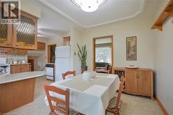 Dining area featuring crown molding and a built-in wall shelf - 