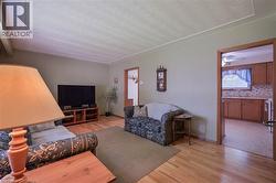 Living area featuring hardwood flooring and light green walls - 