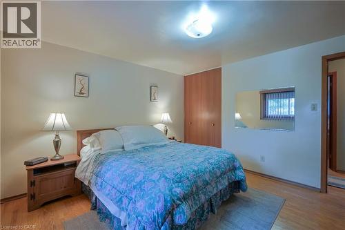 Bedroom featuring wood-finish flooring, light-toned walls, and a ceiling-mounted light fixture - 99 Lorraine Avenue, Kitchener, ON - Indoor Photo Showing Bedroom