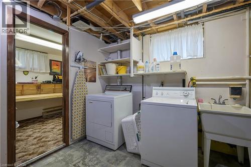 Laundry area featuring a utility sink, a washer, and a dryer - 99 Lorraine Avenue, Kitchener, ON - Indoor Photo Showing Laundry Room