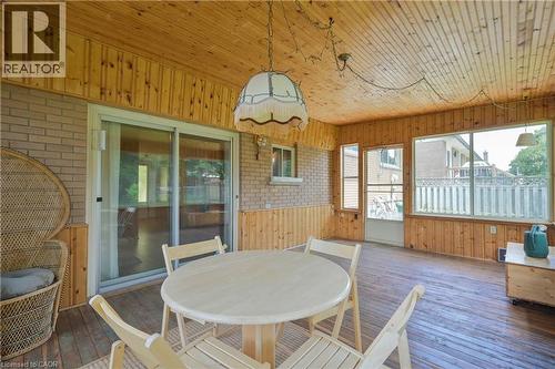 Enclosed patio featuring wood-finish walls and ceiling, large picture windows, and a sliding glass door - 99 Lorraine Avenue, Kitchener, ON - Outdoor With Deck Patio Veranda With Exterior